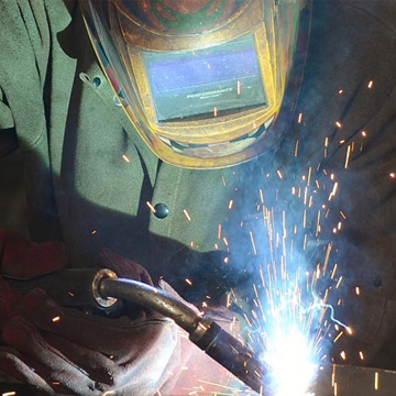 An expert welder in the process of welding