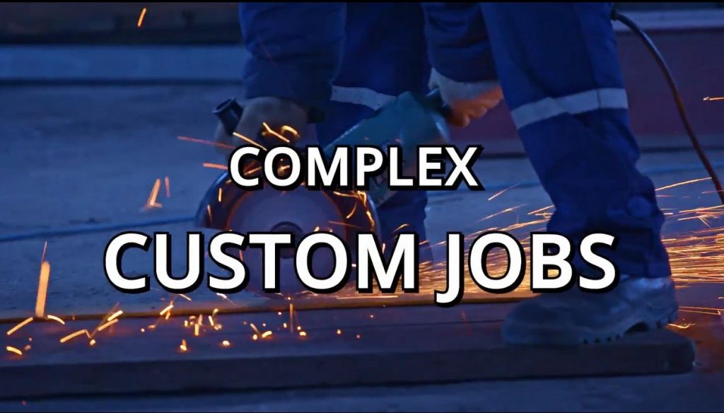 Worker using industrial tools for complex custom metal job